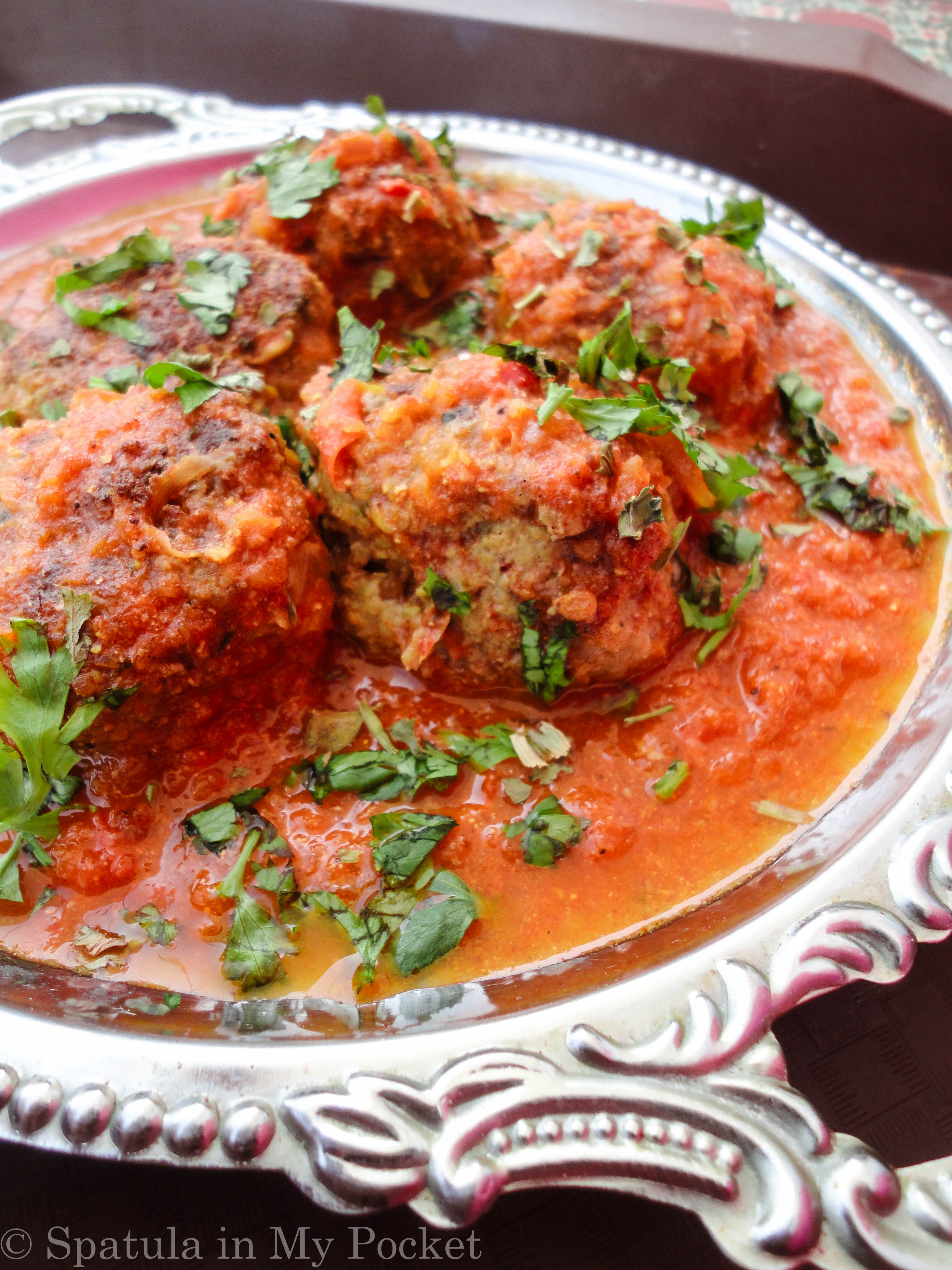 Soft, succulent kebabs smothered in a rich spicy tomato gravy.