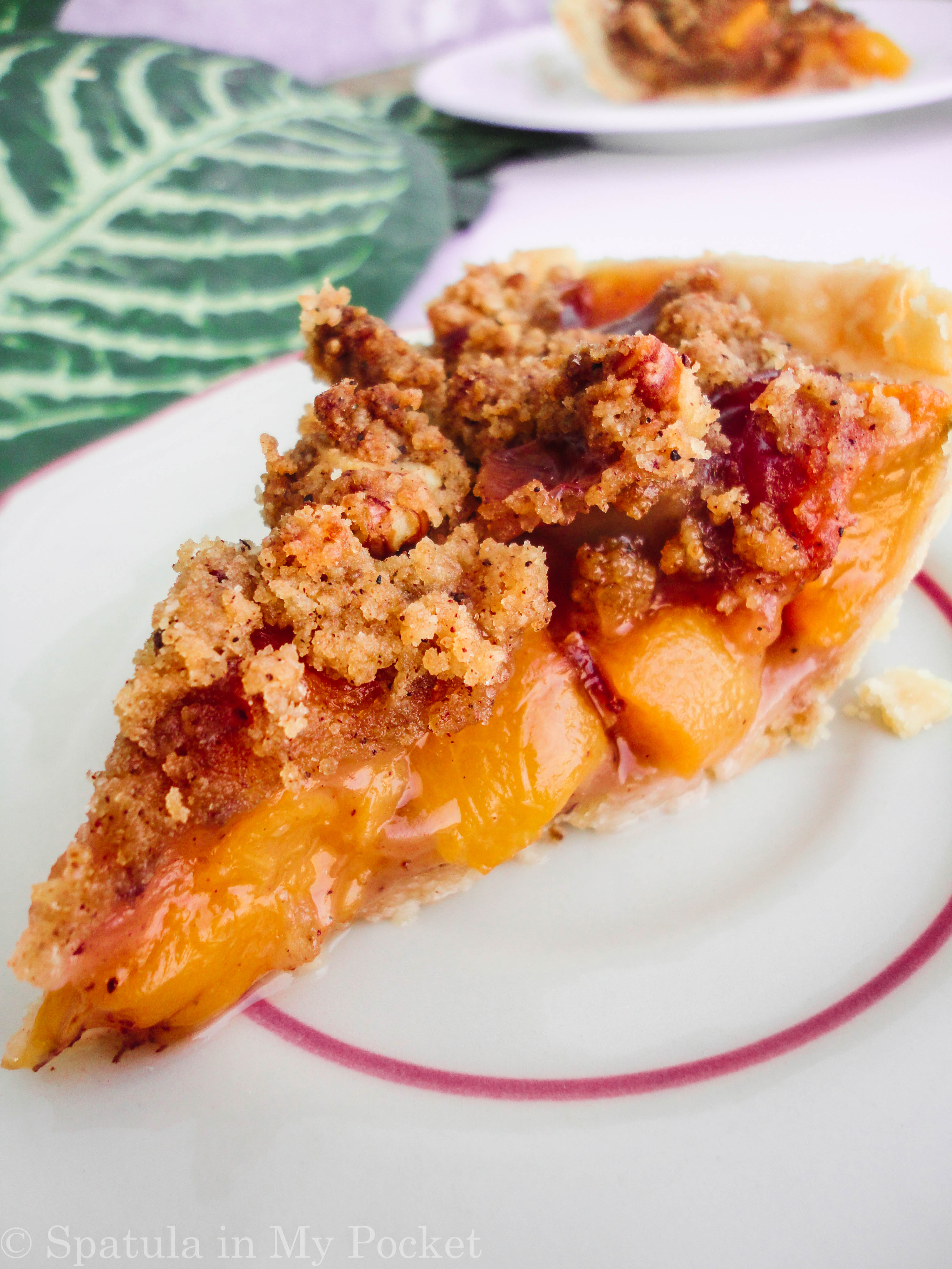 Peach Crumble Pie. A flaky crust filled with juicy peaches and topped with a walnut cinnamon crumble. It’s sweet. It’s juicy. It’s delicious.