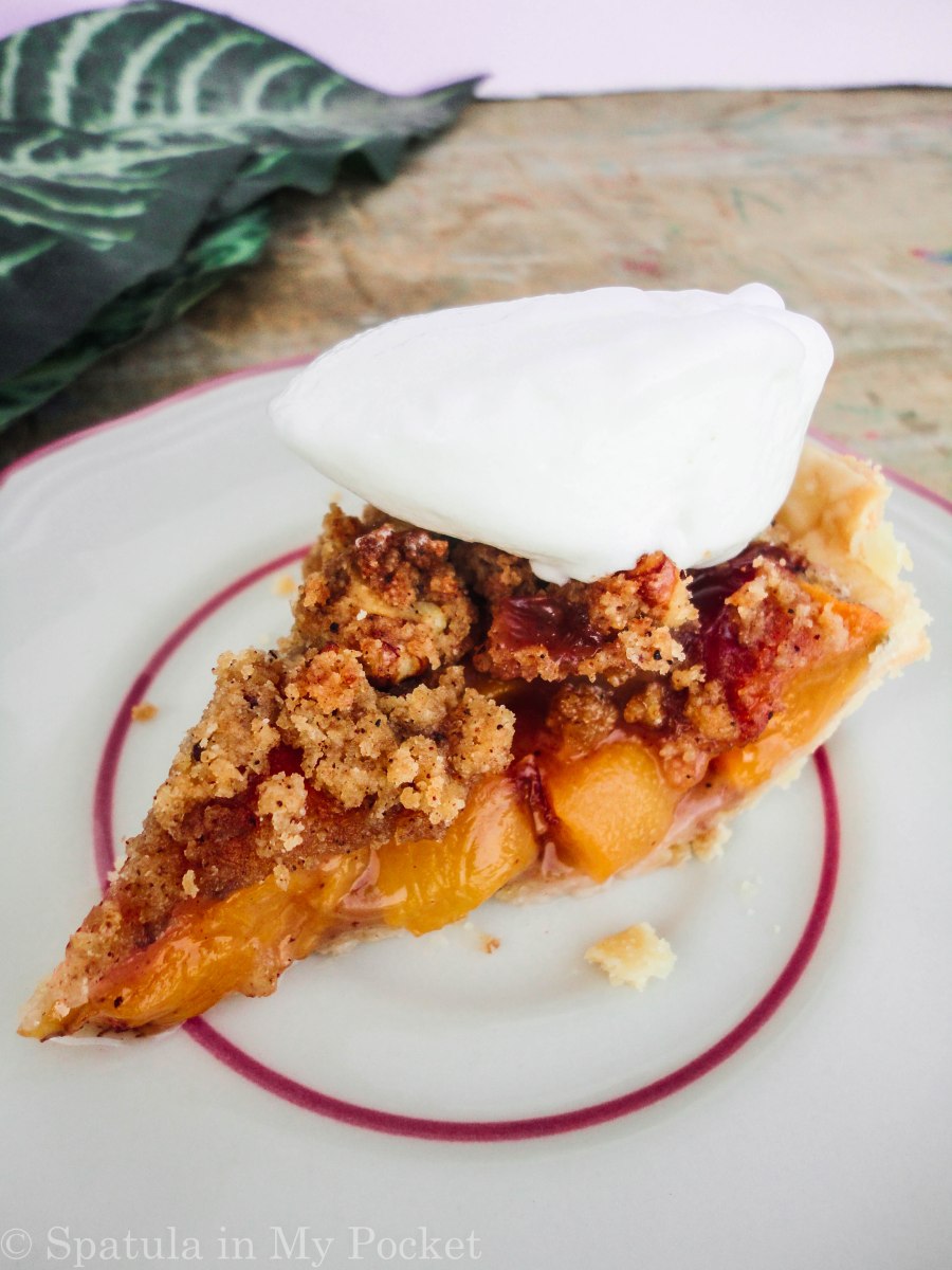 Peach Crumble Pie. A flaky crust filled with juicy peaches and topped with a walnut cinnamon crumble. It’s sweet. It’s juicy. It’s delicious.