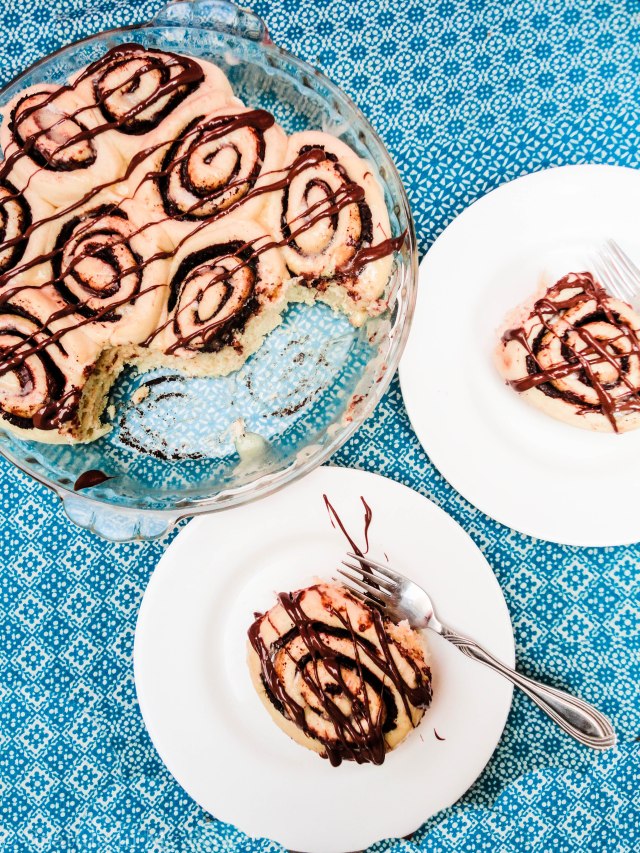 This light fluffy dough, is filled with Nutella and butter and cinnamon, then baked until gooey and brown, and topped with drizzles upon drizzles of cream cheese glaze and more molten Nutella. 