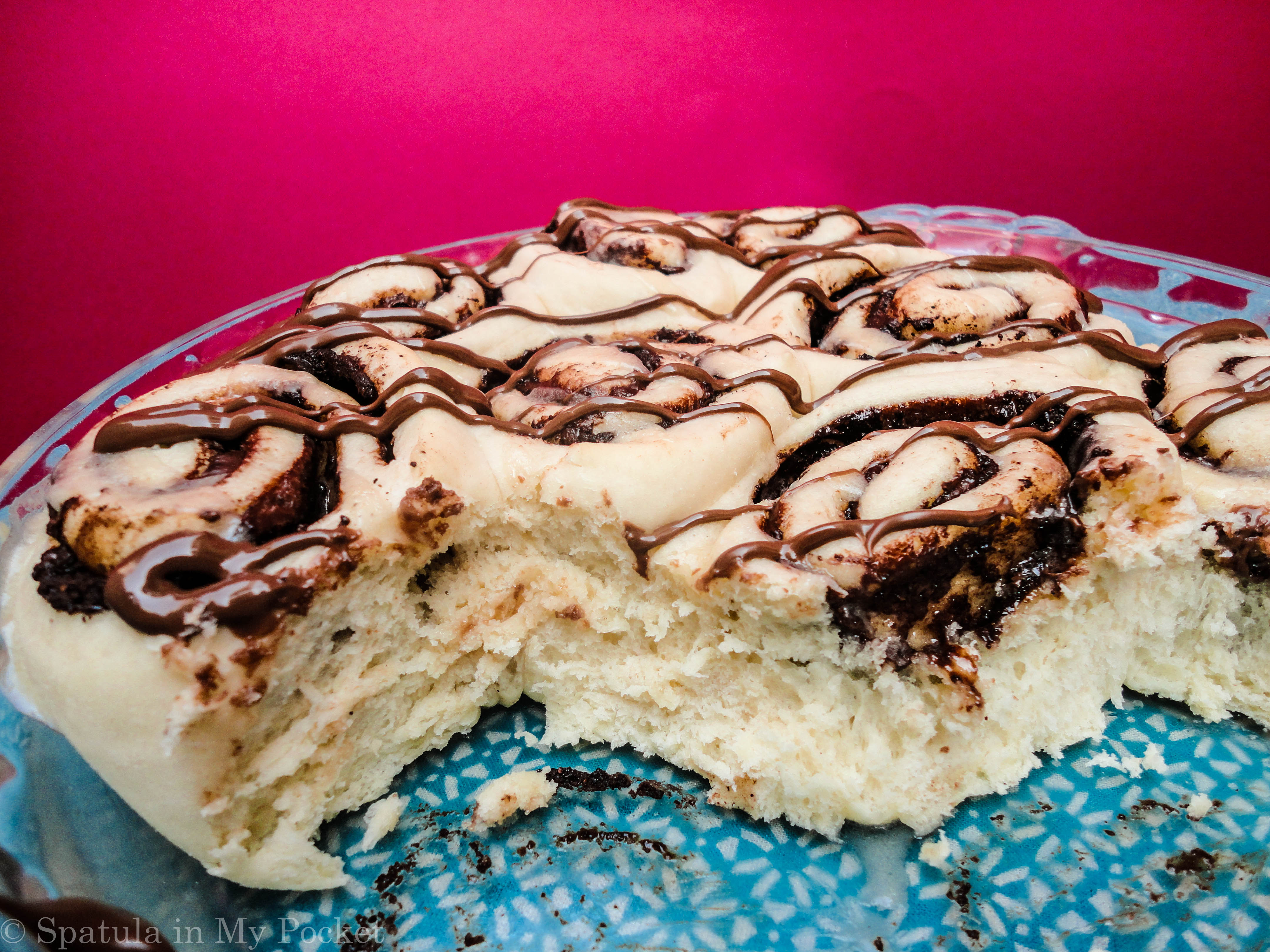 This light fluffy dough, is filled with Nutella and butter and cinnamon, then baked until gooey and brown, and topped with drizzles upon drizzles of cream cheese glaze and more molten Nutella.