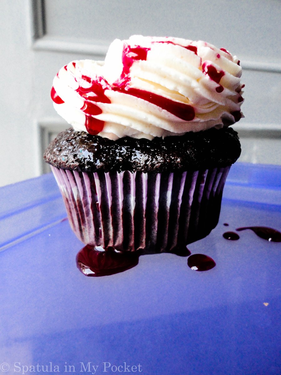 Bloody cupcakes with maggots and gashes.