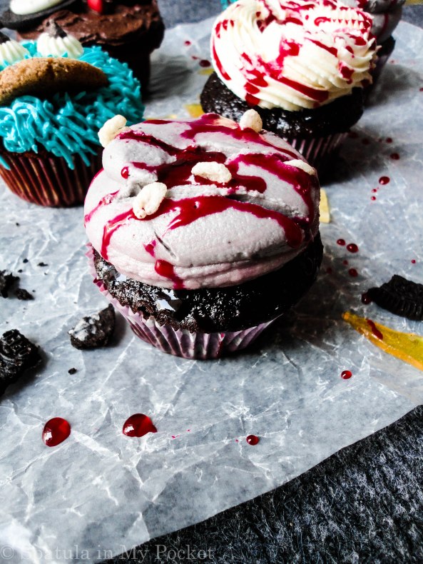 Bloody cupcakes with maggots and gashes.