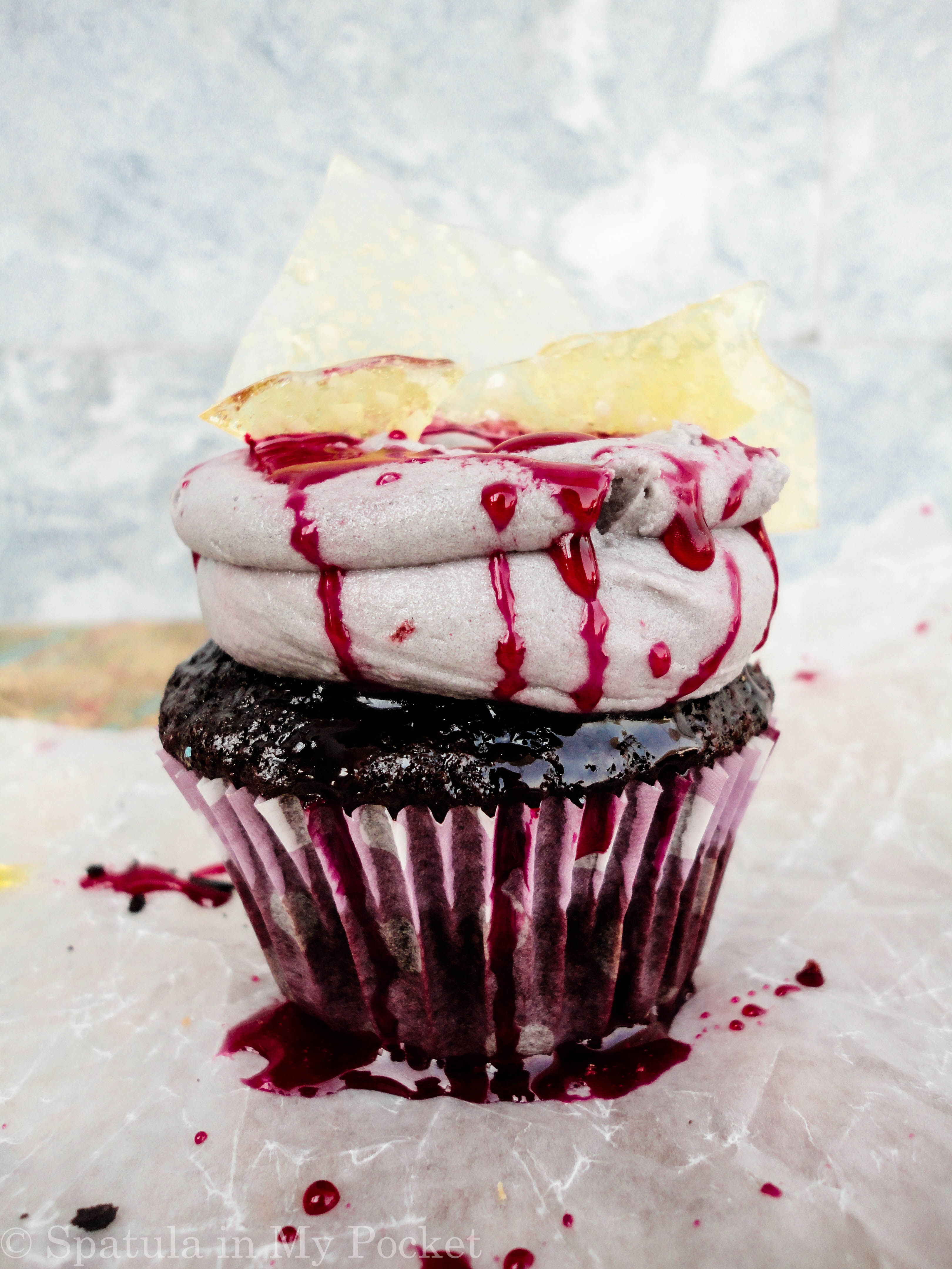 Broken glass cupcakes with gashes and dribbles of blood.